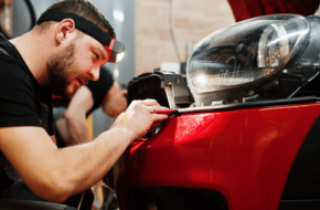 Repairman working on the bumper of a car