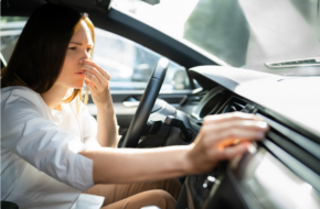 Woman smelling gas in her car