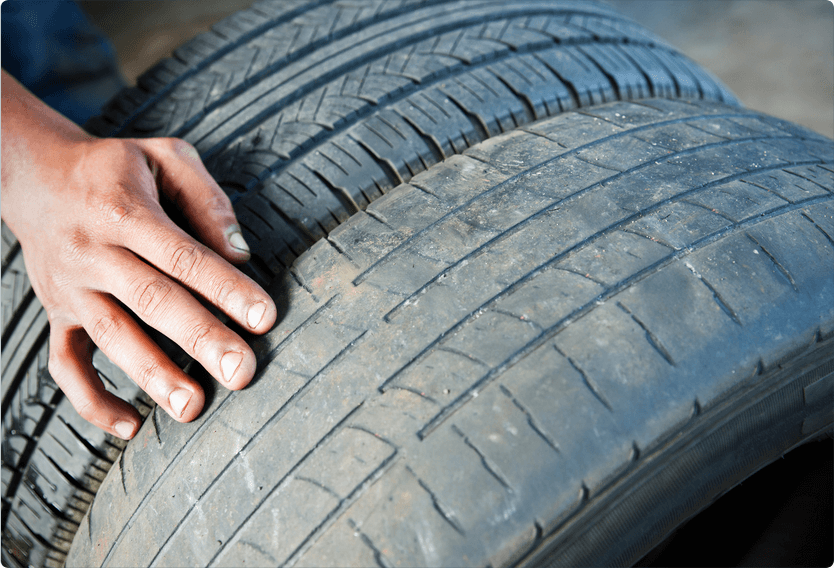 Mechanic pointing out uneven tire wear