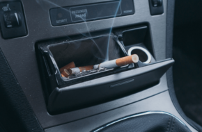 Cigarette in car ashtray