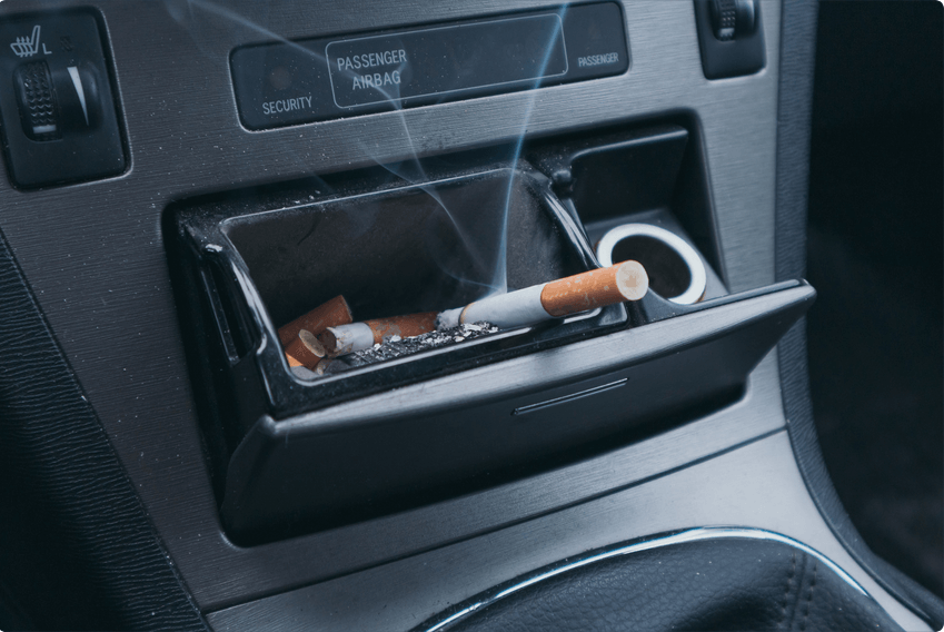 Cigarette in car ashtray